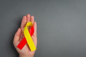 World hepatitis day awareness with red yellow ribbon photo