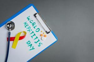 World hepatitis day concept with medical tools photo