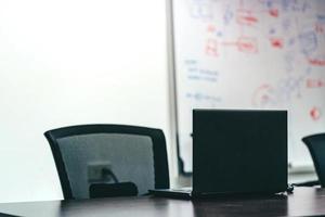 Laptop on black table for business presentation in the meeting room photo