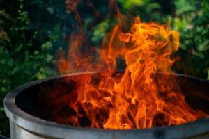 Cement tank at fire flames on blurred background photo