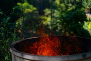 Cement tank at fire flames on blurred background photo