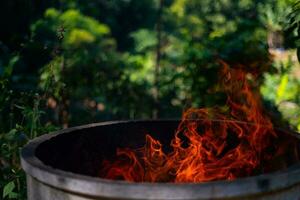 Cement tank at fire flames on blurred background photo