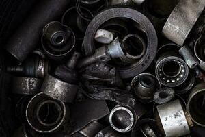 Old dirty broken auto bearings and scrap Iron on flooring photo