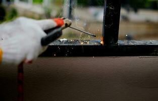 Welder Technician are welding steel with sparks photo