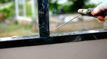 Welder Technician are welding steel with sparks photo