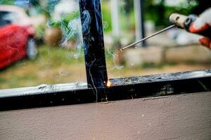 Welder Technician are welding steel with sparks photo