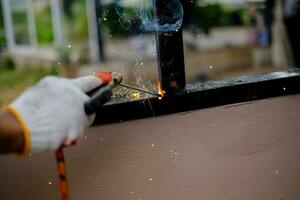 Welder Technician are welding steel with sparks photo