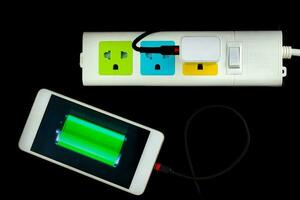 Adapter smart phone charger at plug in power outlet photo