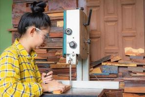 Women standing is craft working cut wood at a work bench photo