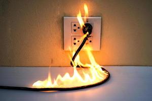On fire electric wire plug Receptacle photo