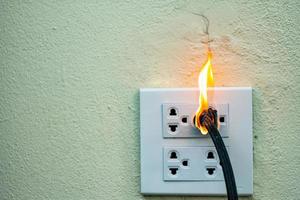 On fire electric wire plug Receptacle photo