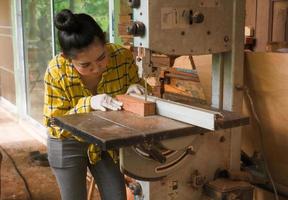 Women standing is craft working cut wood at a work bench photo
