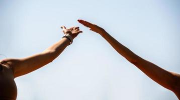 hands of people doing yoga on the beach photo