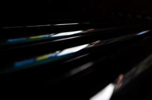 abstract dark black background with shiny metallic lines photo