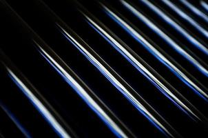 abstract dark black background with shiny metallic lines photo