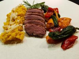 fried Duck breast with saffron risotto photo