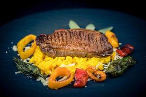 fried Duck breast with saffron risotto photo