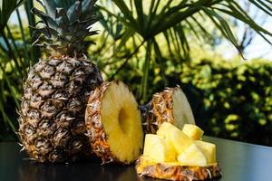 sliced Pineapple in front of Palm trees photo