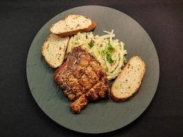 pork knuckle with sauerkraut and bread photo