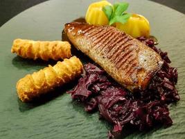 Fried duck breast with red  cabbage and croquettes photo