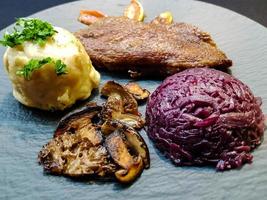 Baked Duck with red cabbage and forest mushrooms photo