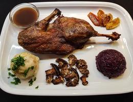 Baked Duck with red cabbage and forest mushrooms photo