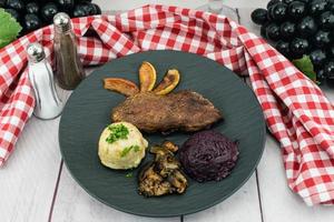 Baked Duck with red cabbage and forest mushrooms photo