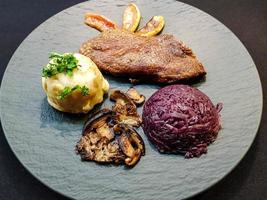 Baked Duck with red cabbage and forest mushrooms photo