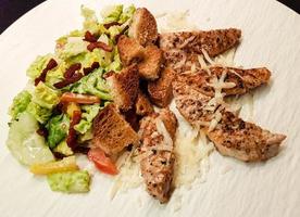 traditional caesars salad with grilled chicken photo