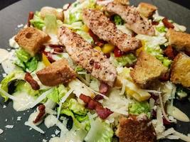 traditional caesars salad with grilled chicken photo