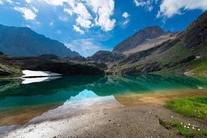 Small high mountain lake with transparent