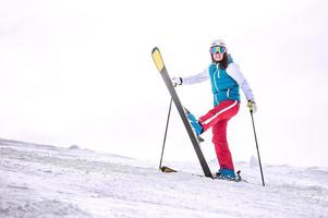 Skiing, winter - happy girl skier on mountain photo