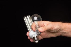 Light bulb in hand on a black background