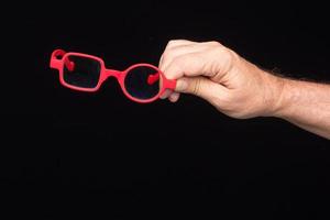 Glasses in the hand of a person photo