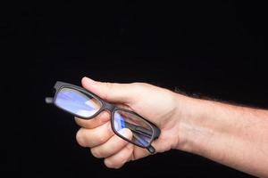 Glasses in the hand of a person photo