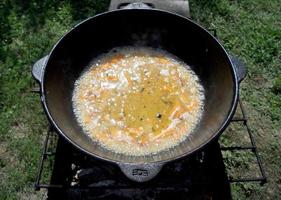 Cast iron bowl pilaf, wide black plate is filled photo