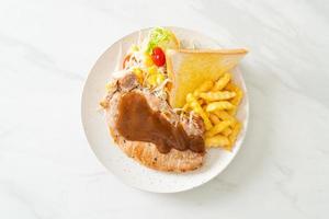 Pork steak with black peppers gravy sauce and mini salad photo