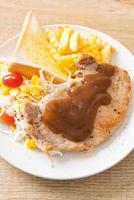 Pork steak with black peppers gravy sauce and mini salad photo