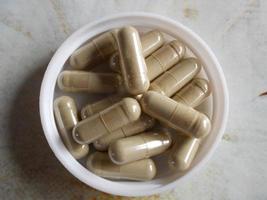 The photo shows medicines, oval capsules