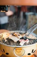 Pork on charcoal grill - Yakiniku - Korean style photo