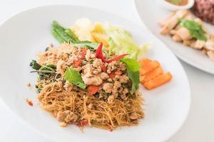 Stir-fried noodle with pork and basil photo