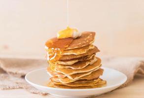 Cheese on pancake stack with honey photo
