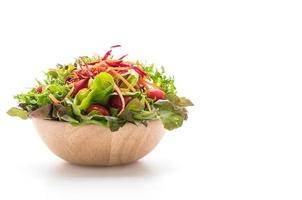 Mixed salad in wood bowl on white background photo