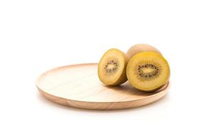 Fresh golden kiwi in wood plate photo