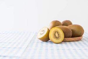 Fresh golden kiwi in wood plate photo