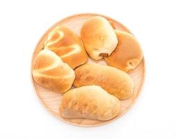 Bread in wood plate on white background photo