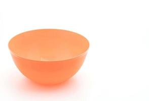 Orange plastic bowl on white background photo