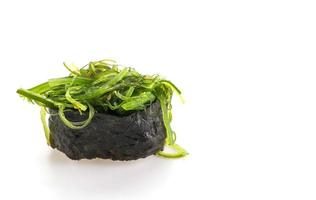 Spicy seaweed salad sushi on white background photo