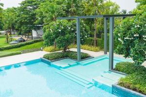 Beautiful luxury swimming pool with palm tree photo