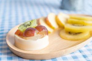 Pudding fruits with kiwi and apple on table photo